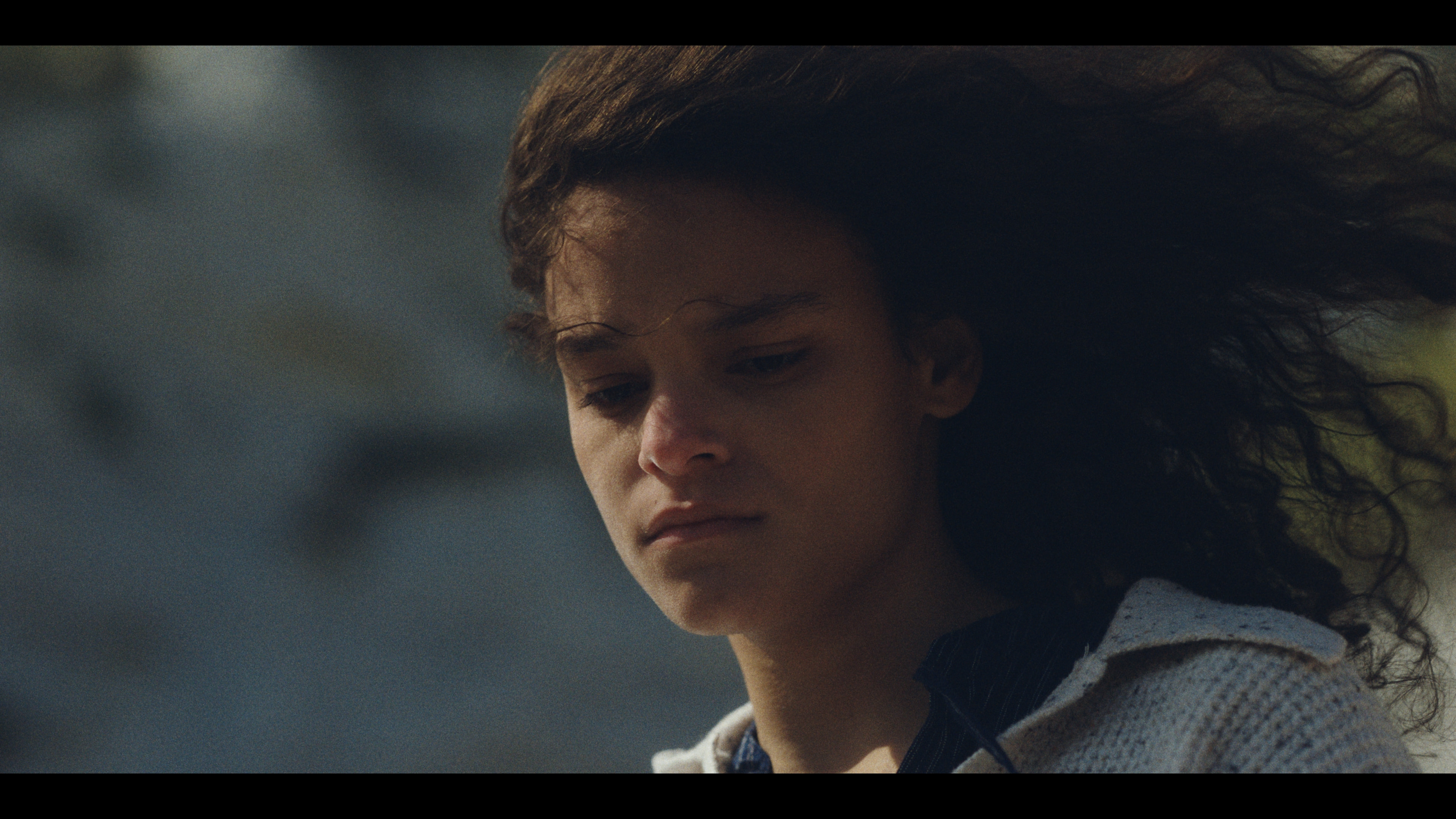 Ori in close-up, tense and watchful.